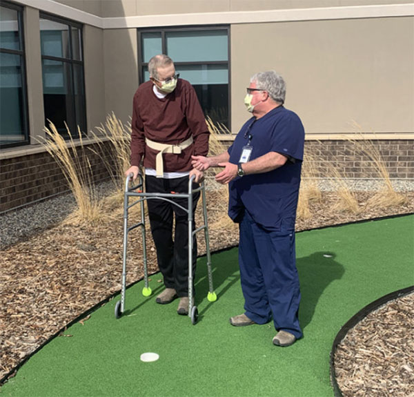 Wayne Martin walks outside with his physical therapist Duane Verhasselt during his recovery at The Rehabiliation Hospital of Montana in Billings.